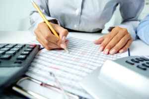 HR professional utilizes their financial knowledge by examining finance spreadsheets